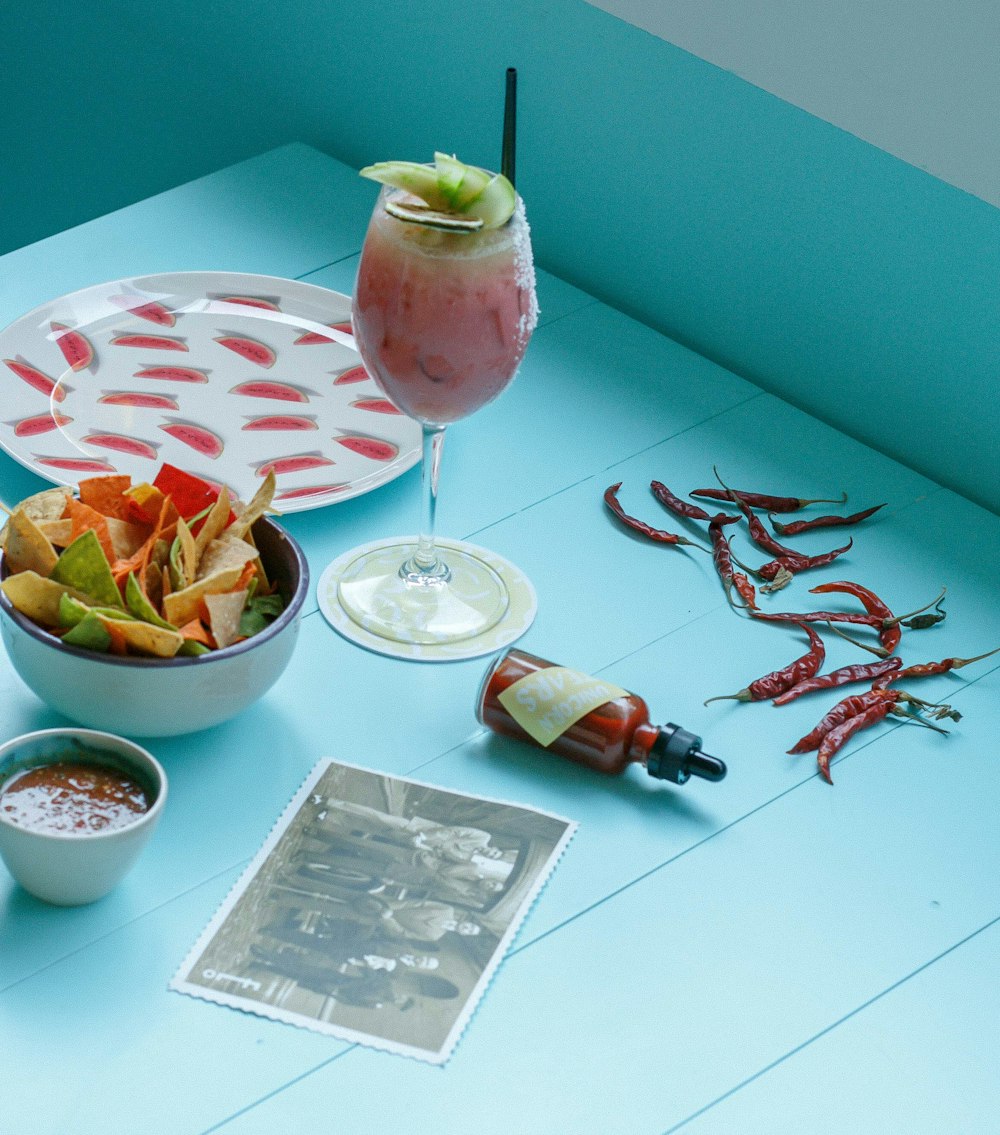 a table with a bowl of food and a drink