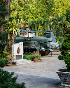 a military vehicle is parked in a garden
