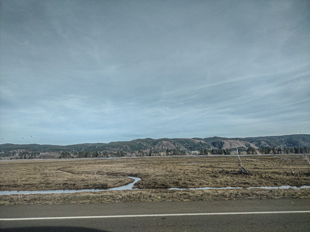 a view of a field from a car window