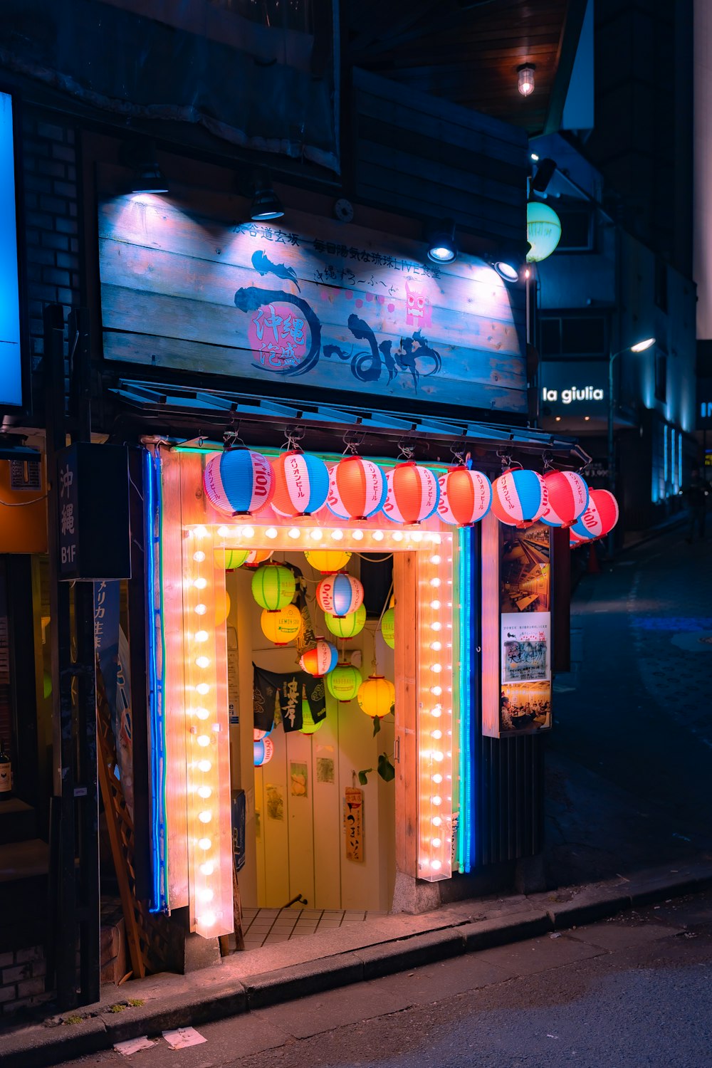 a brightly lit store front with a neon sign