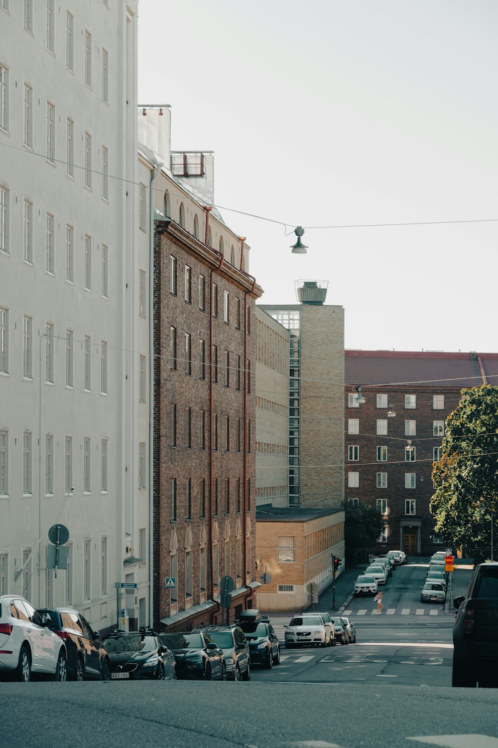 a city street filled with lots of traffic next to tall buildings