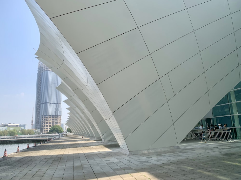 a large white building with a very tall building in the background