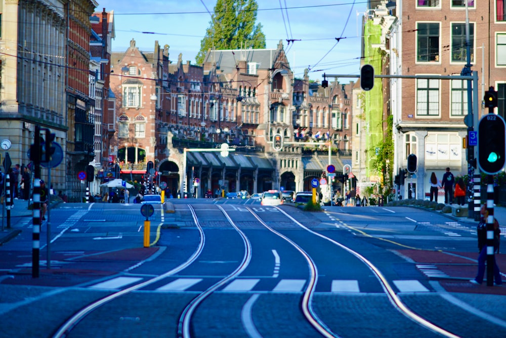 a city street filled with lots of traffic next to tall buildings