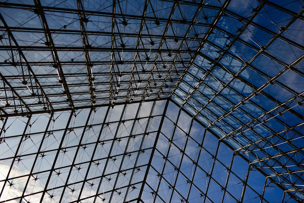 a very tall glass building with a sky in the background