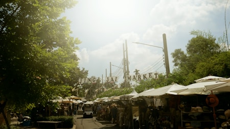a market area with tents and people walking around