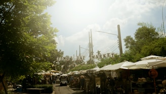 a market area with tents and people walking around