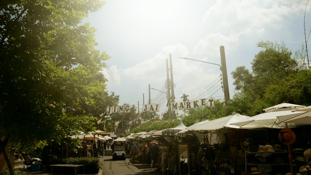 a market area with tents and people walking around