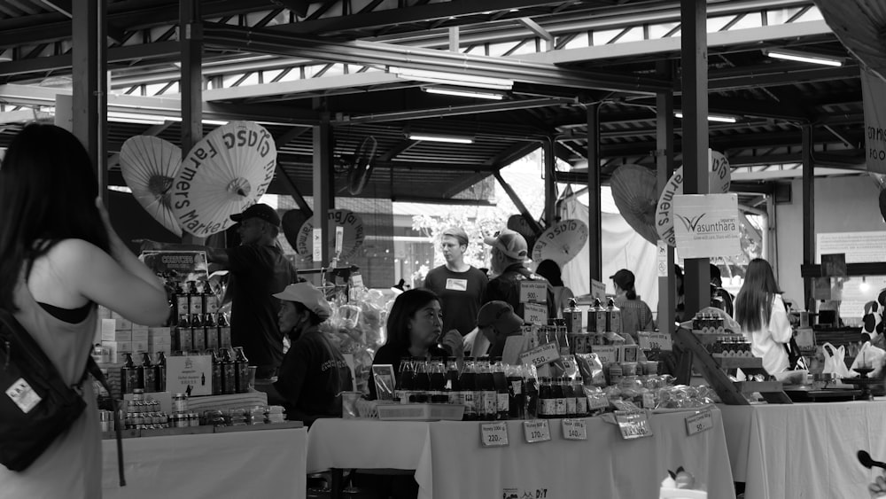 a black and white photo of people at a market