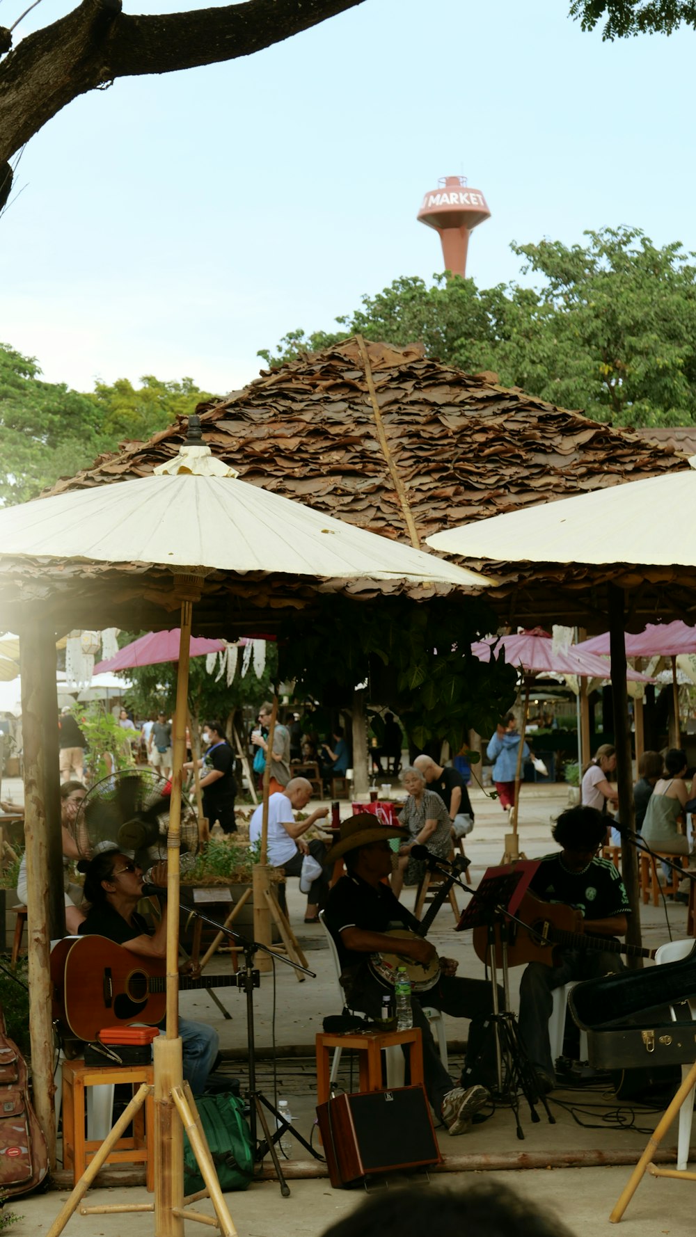 a group of people playing music under umbrellas