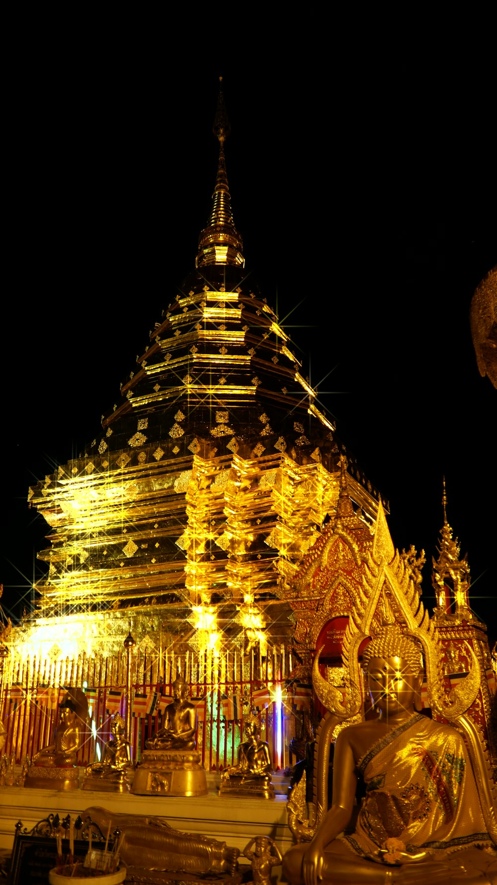 a large golden statue sitting in front of a tall building