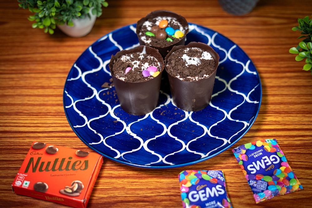 a blue plate topped with chocolate covered donuts