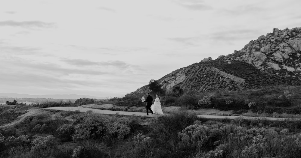 a couple of people that are standing in the grass