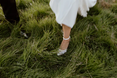 a close up of a bride and groom's shoes