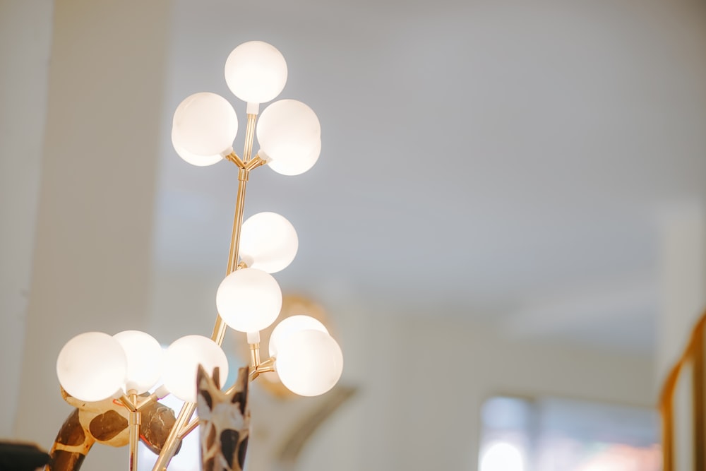 a giraffe standing next to a lamp in a room