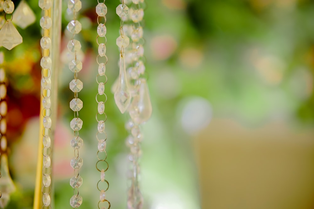 a close up of beads hanging from a tree