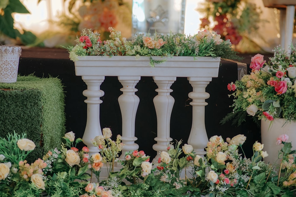 a white planter filled with lots of flowers