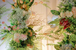 a couple of vases filled with different types of flowers
