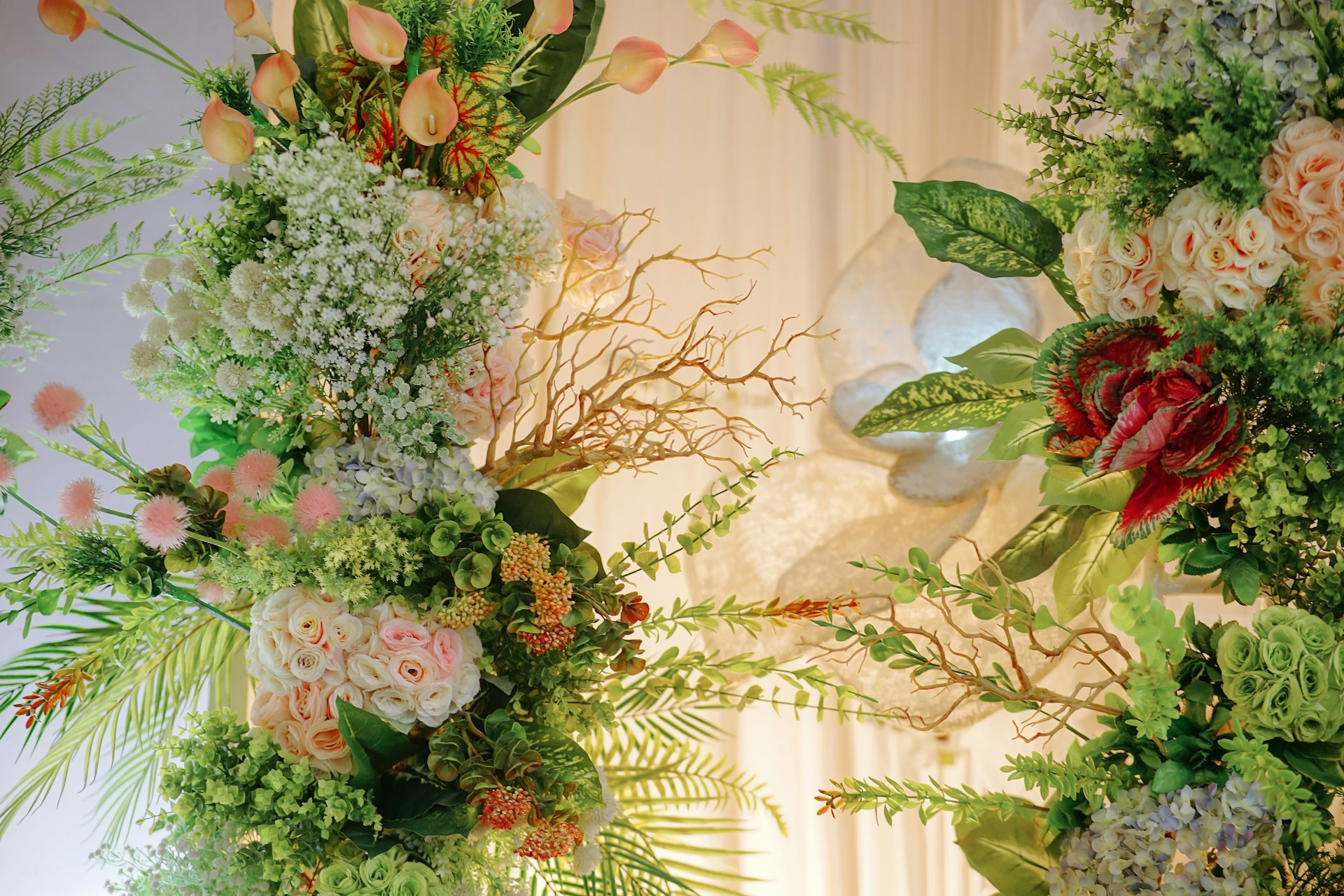 a couple of vases filled with different types of flowers