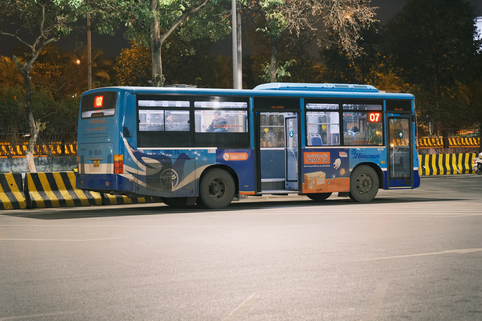Blue airport bus travelling near Noi Bai International Airport in Hanoi, Vietnam