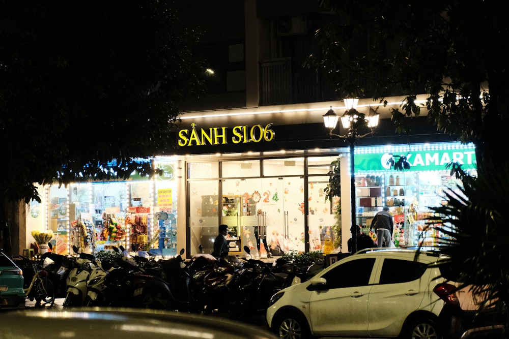 a car parked in front of a store at night