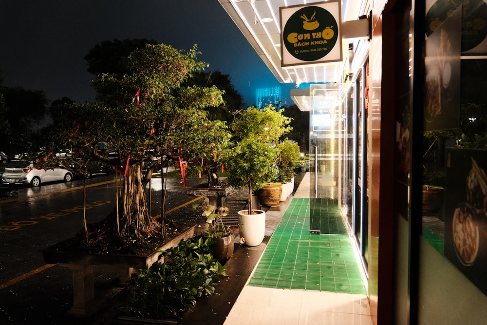 a view of a restaurant from outside at night