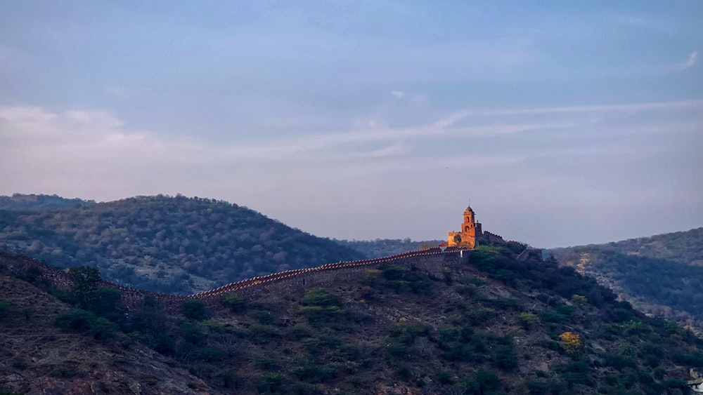 a tall tower on top of a hill