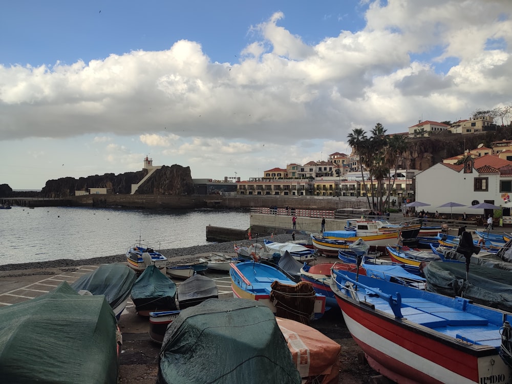 a bunch of boats that are sitting in the sand