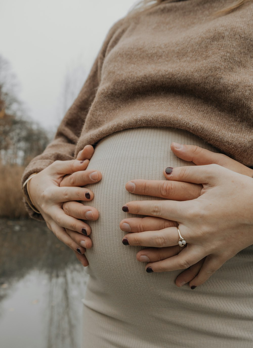 a pregnant woman with her hands on her belly