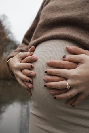 a pregnant woman with her hands on her belly