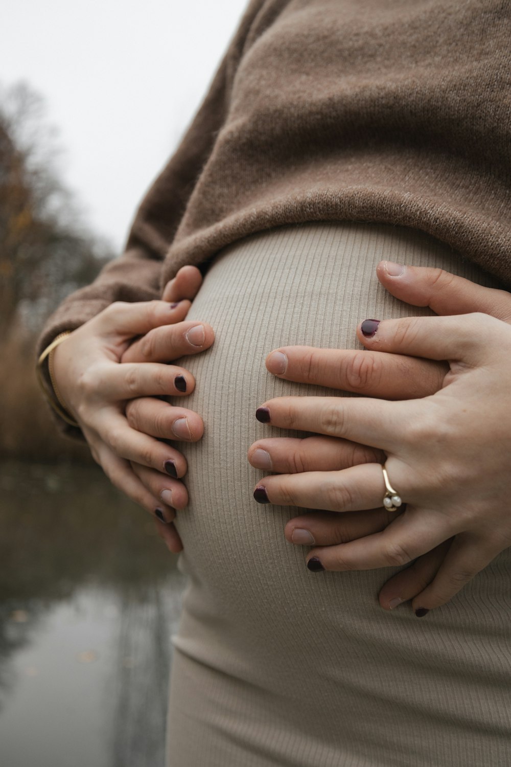 a pregnant woman with her hands on her belly