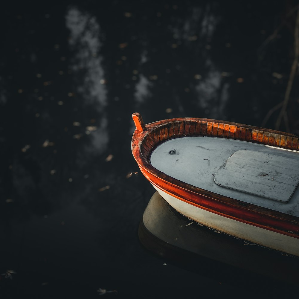 a small boat floating on top of a body of water