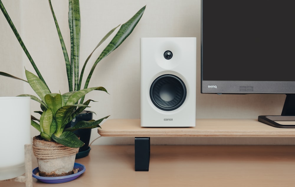 a computer monitor sitting on top of a wooden desk