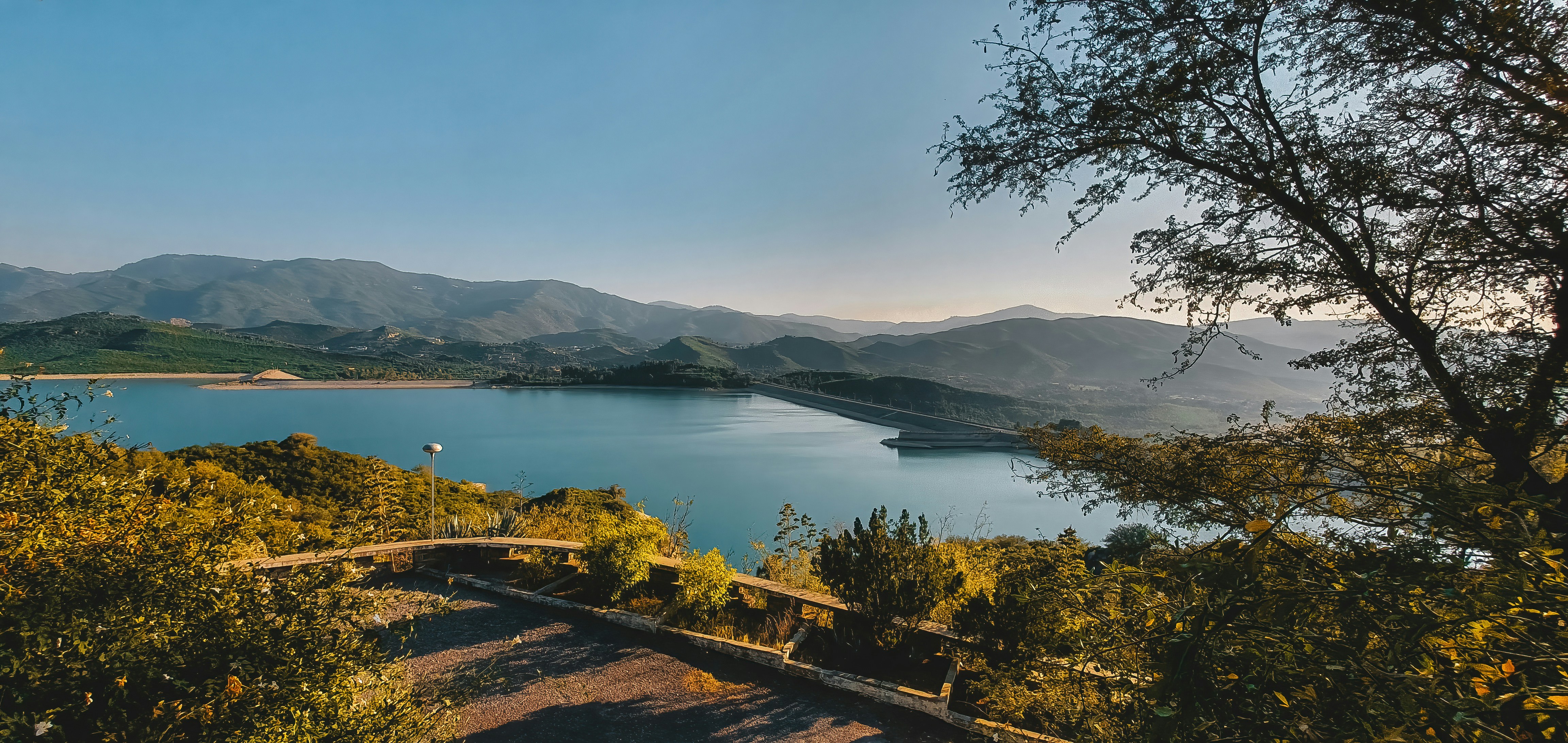 a scenic view of a lake surrounded by mountains