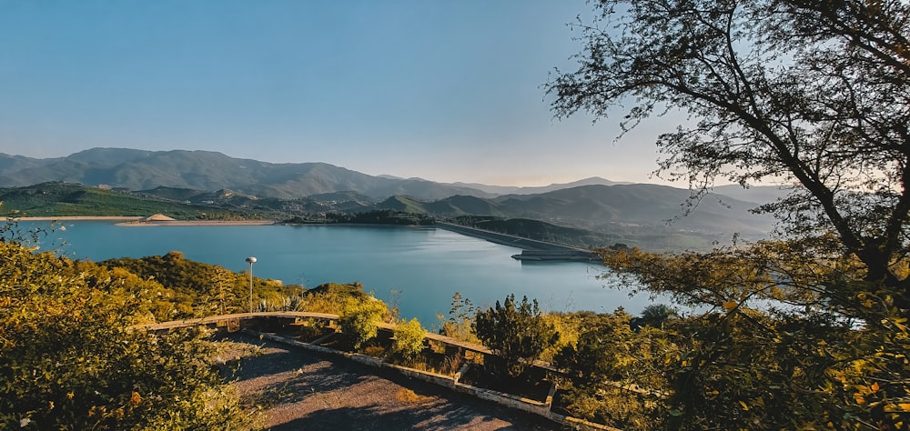 a scenic view of a lake surrounded by mountains