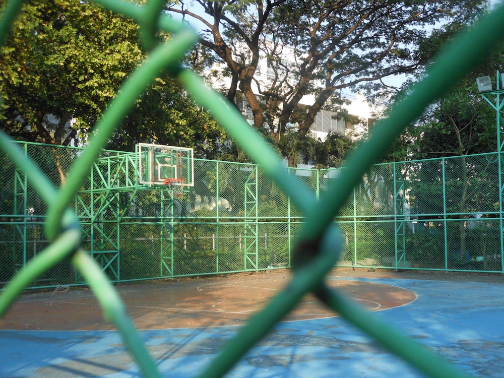 a basketball court through a fenced in area