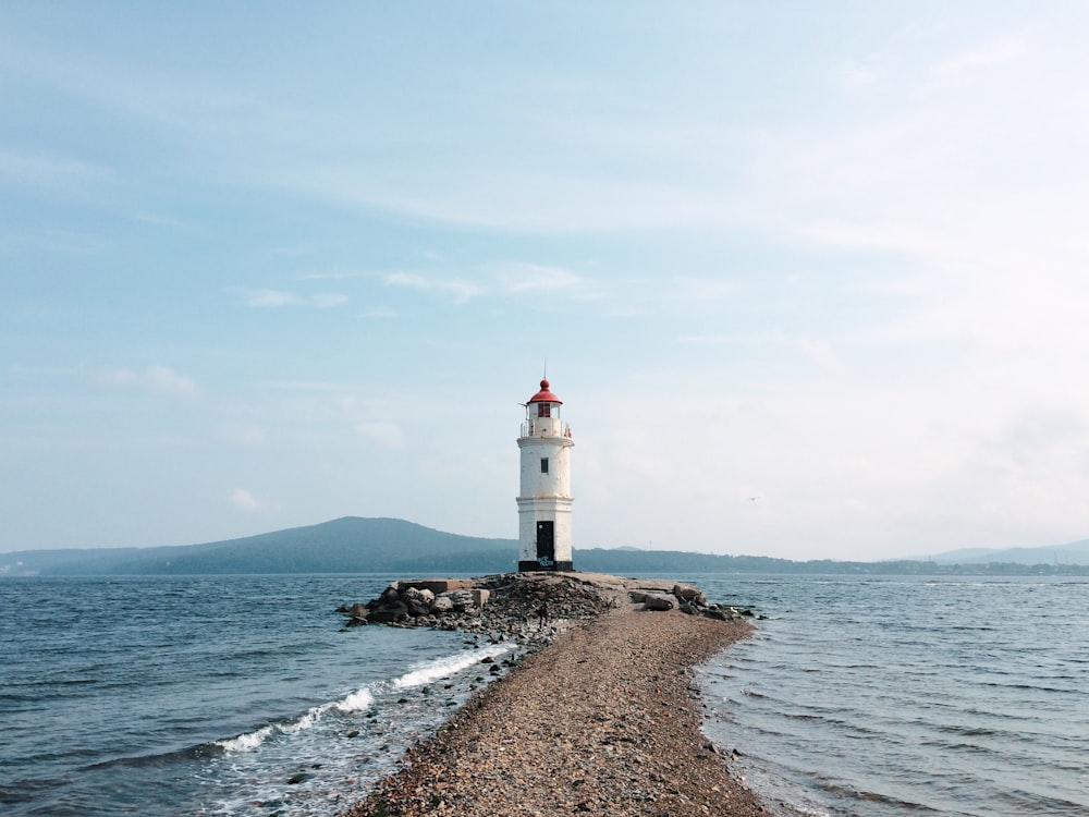 a light house sitting on top of a rocky shore