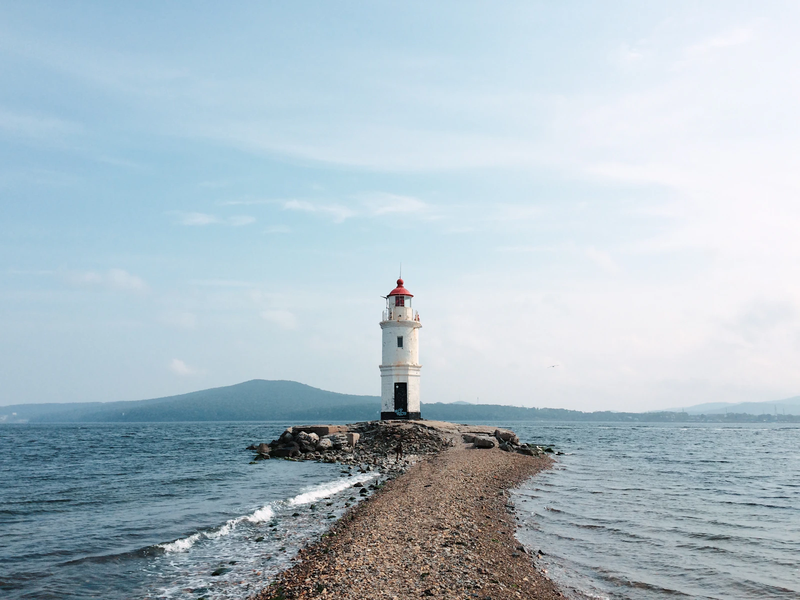 a light house sitting on top of a rocky shore