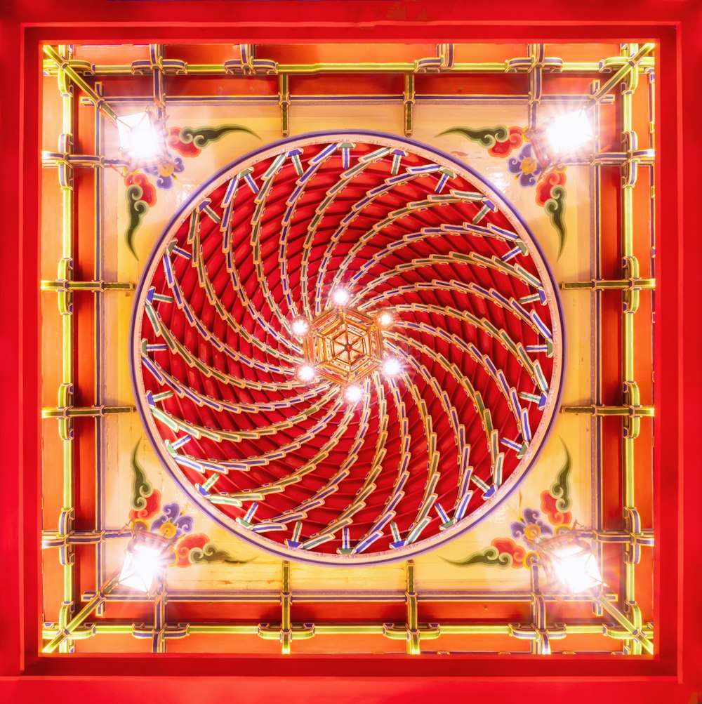 a red and yellow square with a spiral design
