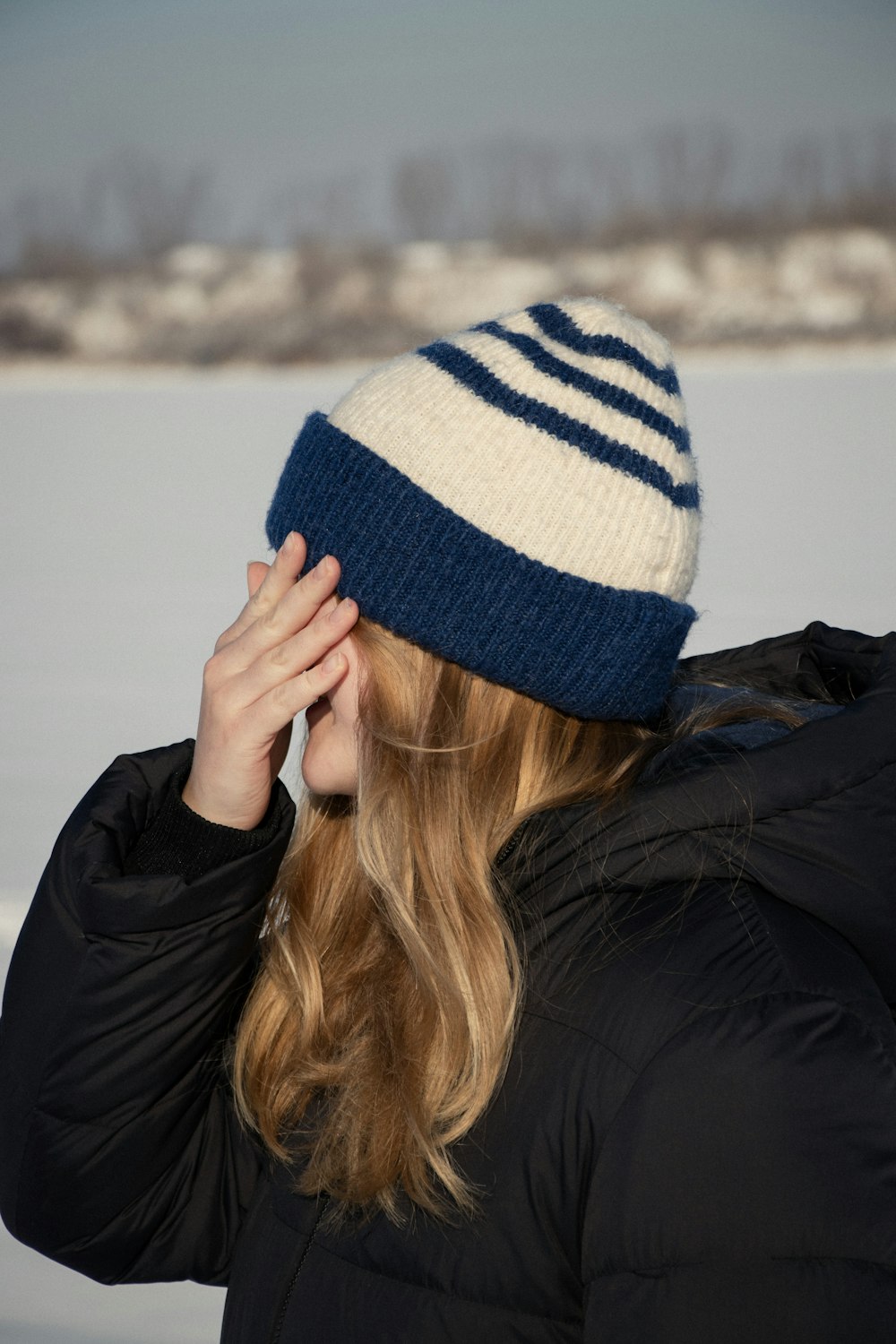 a woman wearing a blue and white striped hat