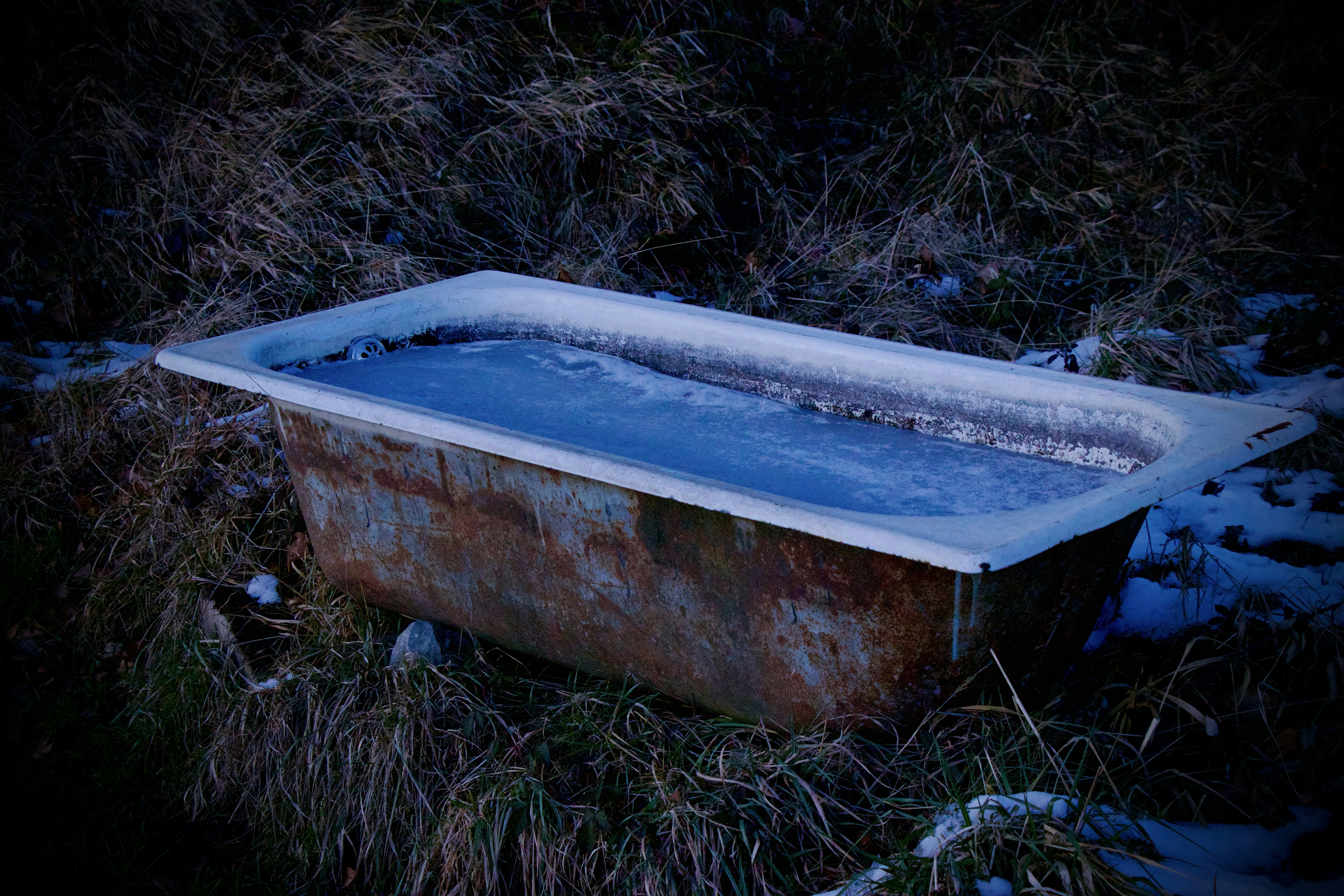 Frozen water in a rusty bath tub