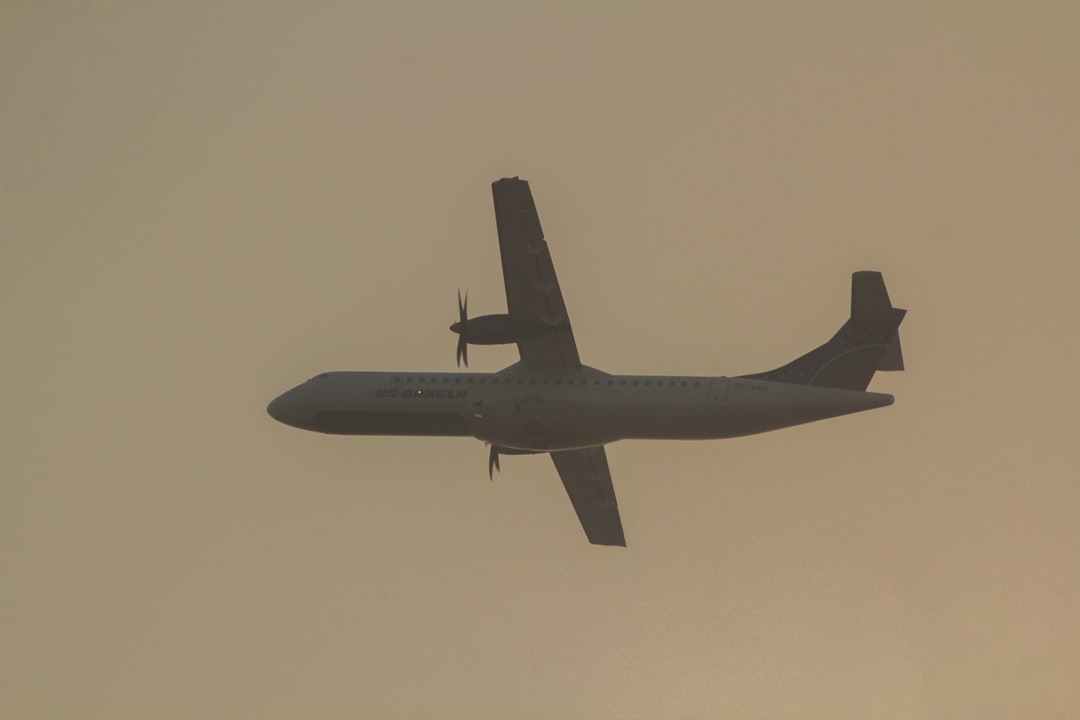 an airplane is flying in the sky on a hazy day, ATR72-600 of US-Bangla.