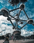 a group of people standing around a metal structure