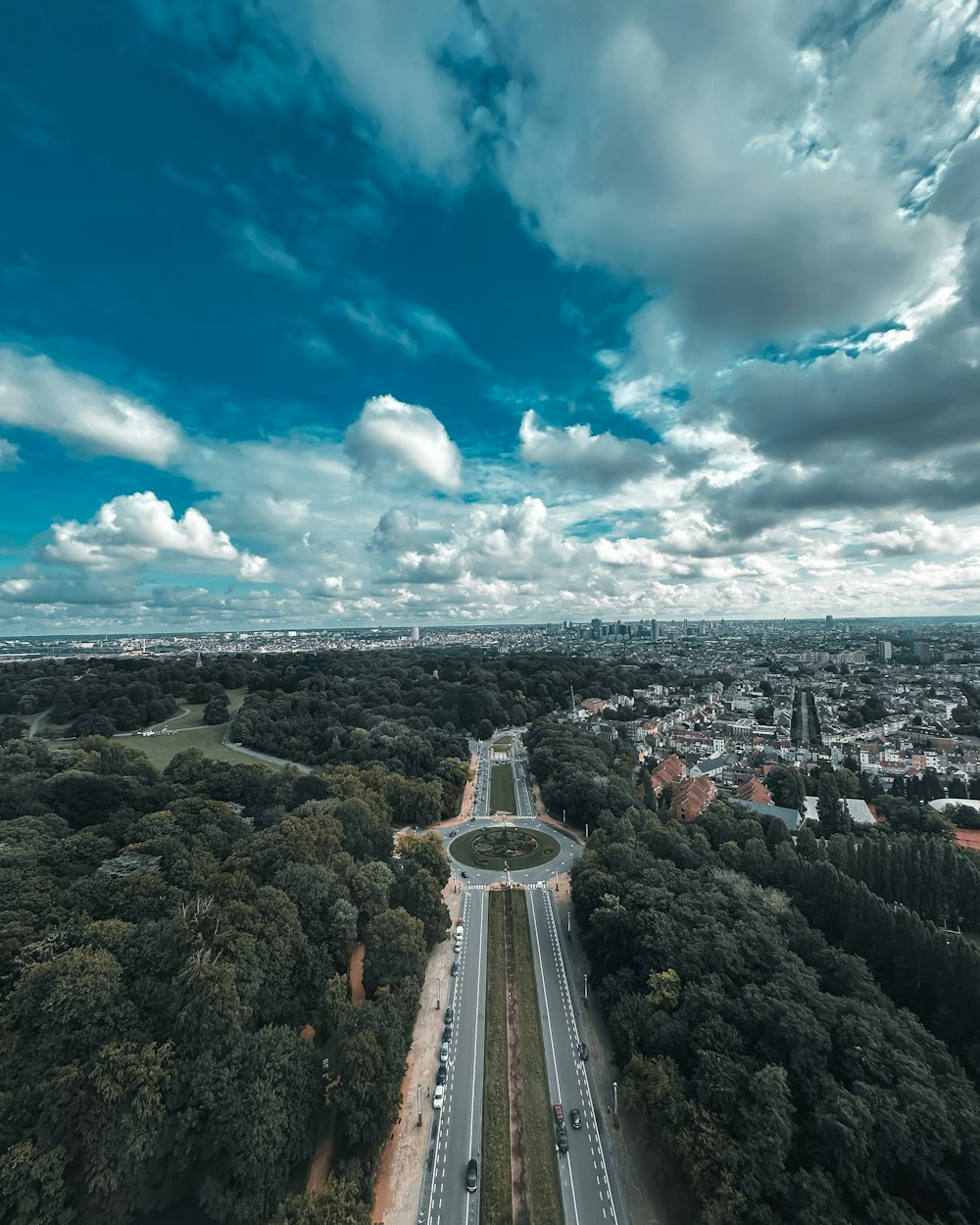 an aerial view of a highway in the middle of a forest