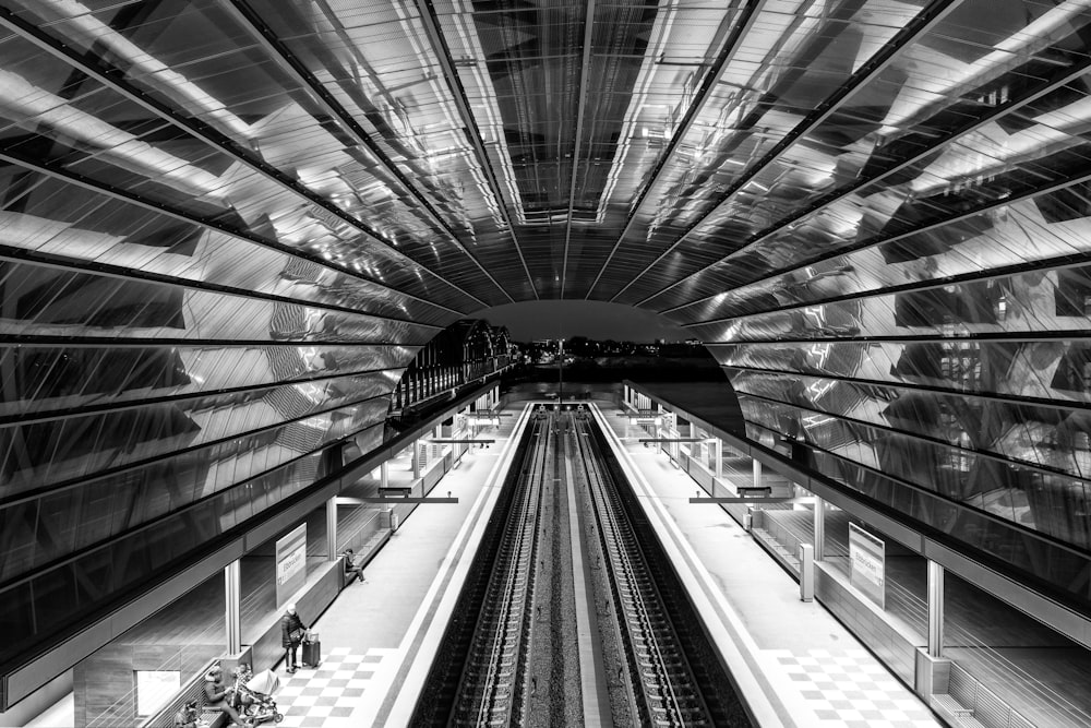 a black and white photo of a train station