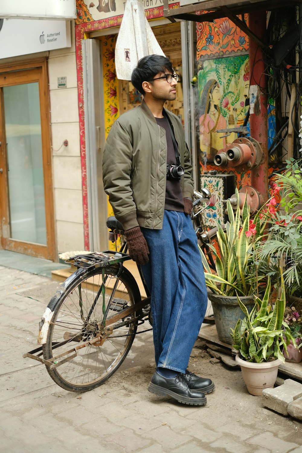 a man is standing next to a bicycle