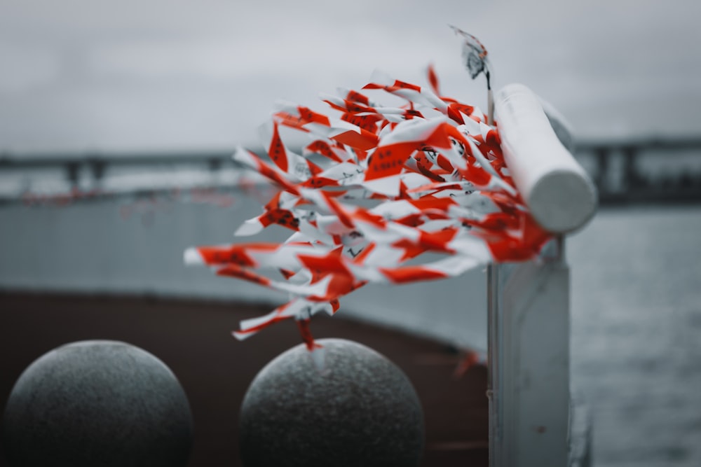 a bunch of red and white confetti on a pole