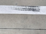 a close up of a piece of paper on a sidewalk