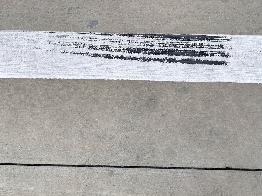 a close up of a piece of paper on a sidewalk