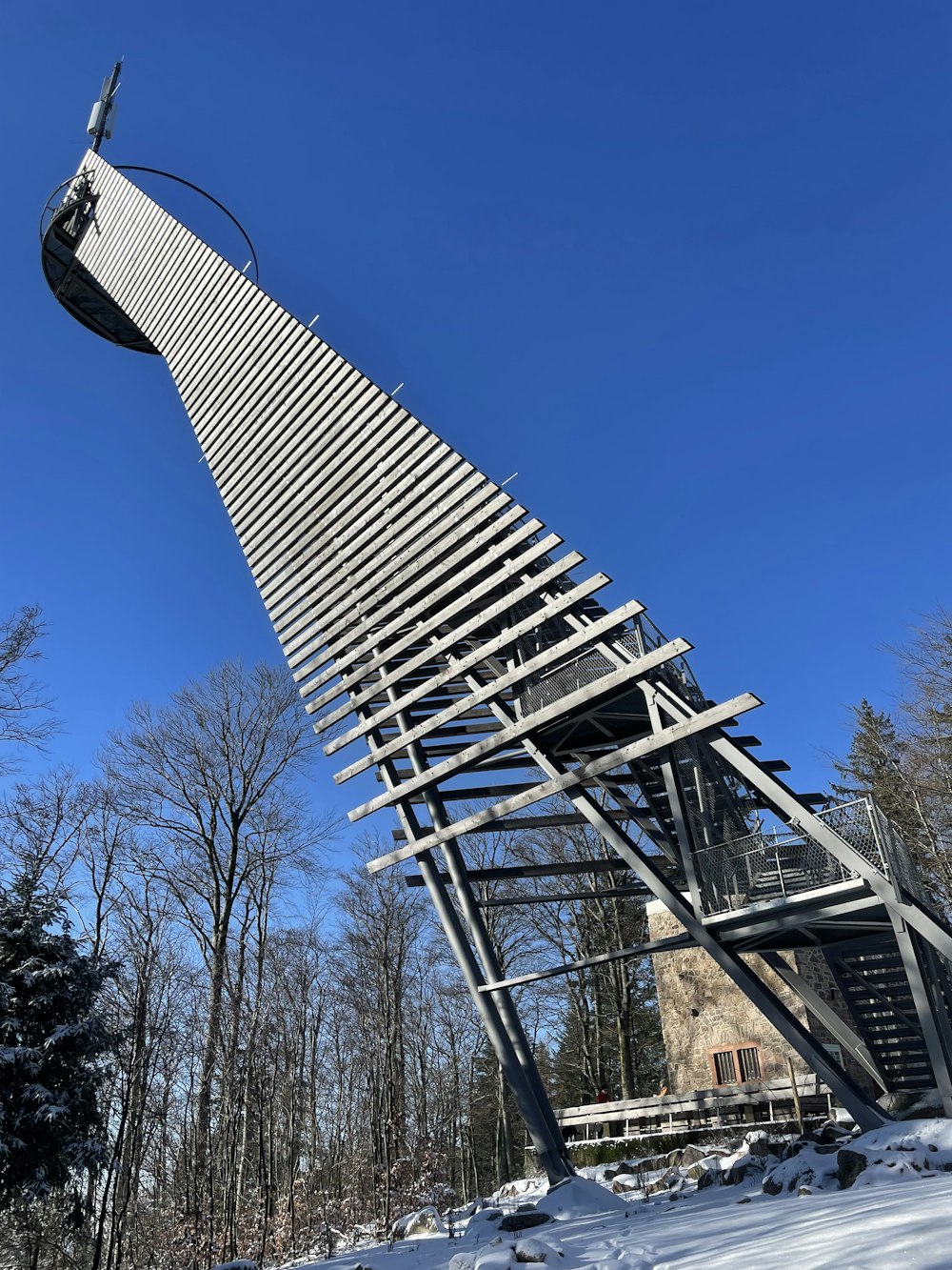 a very tall metal structure in the snow