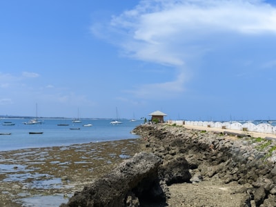 a sandy beach with boats in the water
